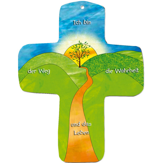 Illustration eines metALUm Wandkreuzes: ein gewundener orangefarbener Weg führt zu einem Baum auf einem Hügel bei Sonnenaufgang. Mit deutschem Text: "Ich bin der Weg die Wahrheit und das Leben" - das Kreuz als Geschenk und Brot des Lebens.